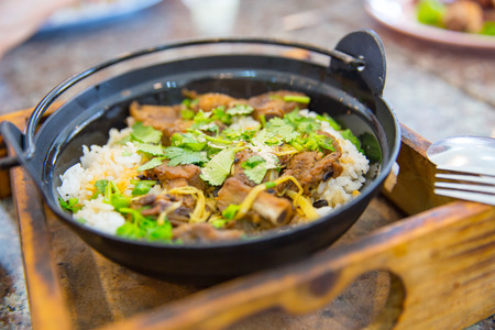 Thai food Roasted pork with jasmine rice with fresh green cilantro or coriander leaves.の写真素材