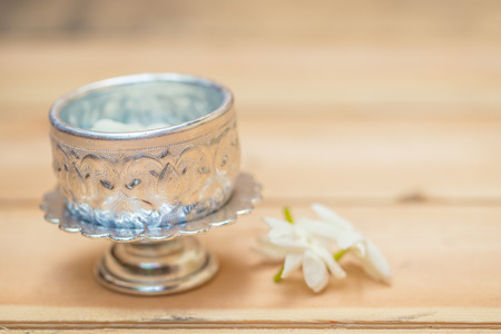 Thailand Songkran festival decoration concept, water in silver bowl with jasmine white flower.の写真素材