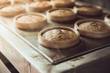 Chinese hot steam cooking food Yumcha or Dim sum in Bamboo Steamer Basket vintage color toneの写真素材