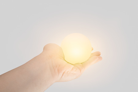 power of giving or give energy concept. hand hold white light miracle ball effect.の写真素材