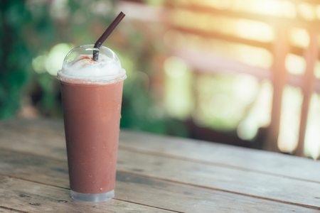 Iced blend smoothie milk chocolate whip cream on wood table with space for textの写真素材