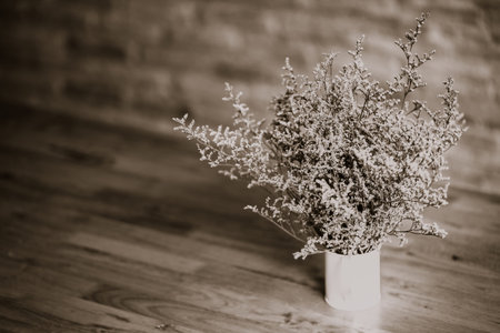 dramatic flowers dried in vase on wood table vintage toneの写真素材