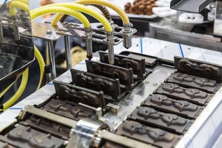 cake hot mold baking machine. food mass production machinery in food factoryの写真素材