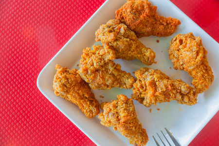 kentucky style fried chicken on red background with space for textの写真素材