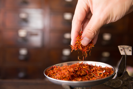 Safflower for diet tea and healthy low fat cooking oil herbal in herb store backgroundの写真素材