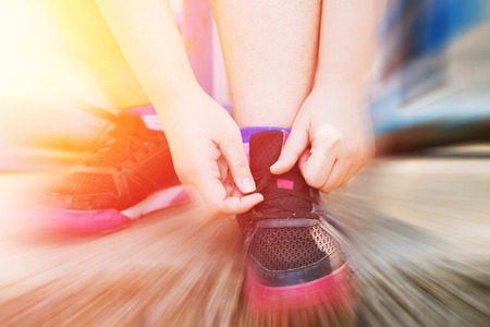 Ready to sport concept Fat women tide her shoes for go exercise healthy diet with blur moving effectの写真素材