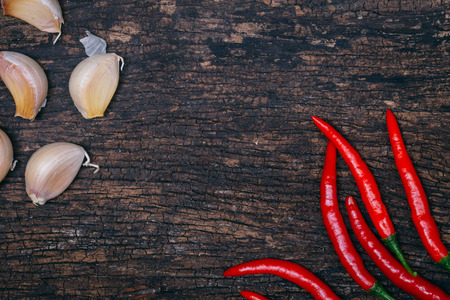 chilli and garlic on wood background with empty space for text hot and spicy for menu backgroundの写真素材