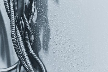 Flexible Steel Conduit  metal water flex pipe in bathroom with space for textの写真素材