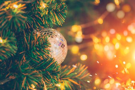 Christmas tree decorated with blur sparkling fairy candlelight bokeh backgroundの写真素材