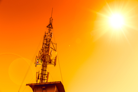 communication tower station with red hot sunset skyの写真素材