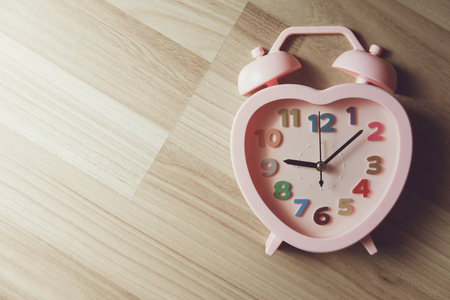 love memory heart clock on wood background vintage color toneの写真素材