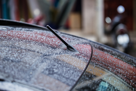 Car radio antenna FM-AM in wet roof rainingの写真素材