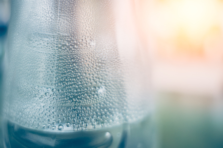 Water humid and condense transform to drops around the bottleの写真素材