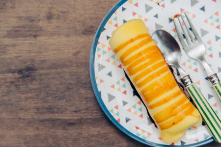 Yellow Banana Roll served on wooden table sweet menuの写真素材
