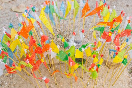 colorful paper flag in the temple sand heap in Songkran festival northern culture in Thailand.の写真素材