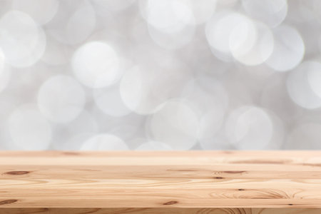 blur white bokeh background with wooden table space for display products designの写真素材