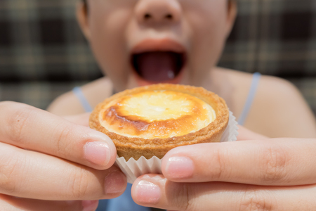 Cheese Egg Tart with Fat Woman open mouth eatingの写真素材