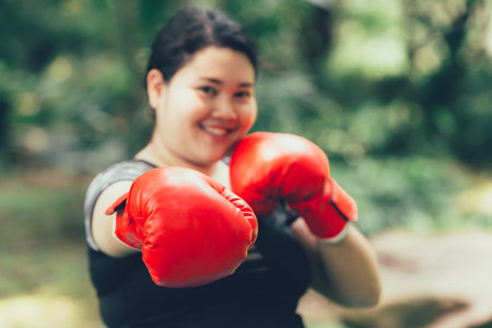 Big Asian woman boxing fighter with fat and diet conceptの写真素材