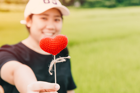 Cute fat girl teen giving heart love concept with space for textの写真素材