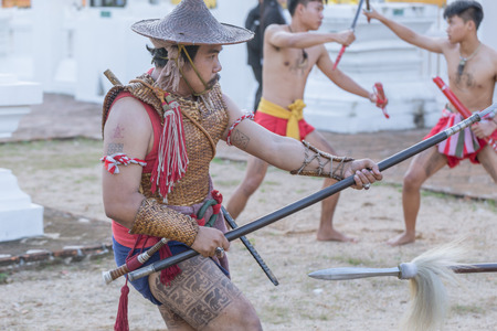 Thai ancient warrior swordsmanship fighting action with sword and spear weapon in Northern Lanna culture and Arts show in 14 January 2017 Lampang Thailand.のeditorial素材