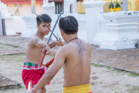 Thai ancient warrior swordsmanship fighting action with sword and spear weapon in Northern Lanna culture and Arts show in 14 January 2017 Lampang Thailand.のeditorial素材