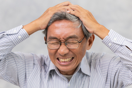 Asian elder suffer from stroke and powerful headache or brain attackの写真素材