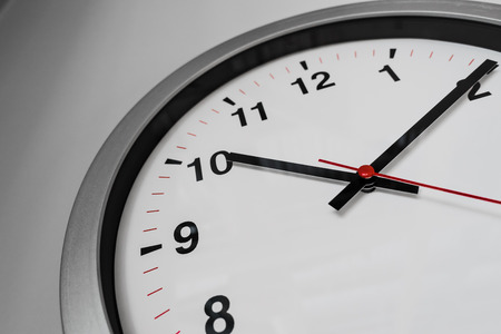 Closeup clock on the wall for Business hours on time concept.の写真素材