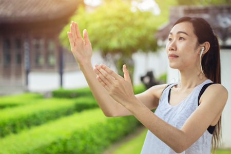 Tai chi, Chinese girl teen practice yin yang force peaceful in the garden for good healthy. selective focus at handの写真素材