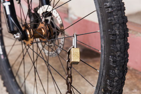 old bicycle strong security lock with key chain at front wheelの写真素材