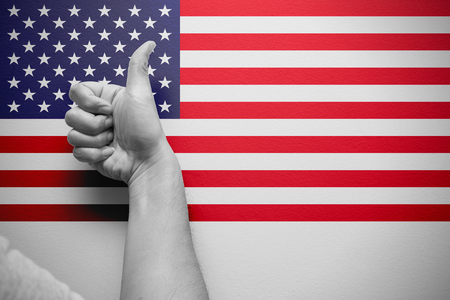 good america thumb up hand with american flag backgroundの写真素材
