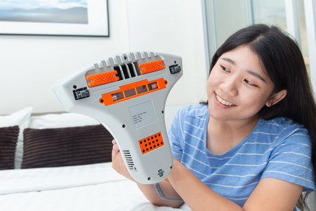 Girl enjoy using mite vacuum cleaner using cleaning bed mattress dust eliminator with UV lamp
