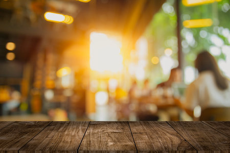 wooden table top blank space with cafe interior blur design for advertising template mockup montage...