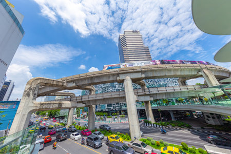Bangkok traffic road with colorful taxi and BTS skyrail way public transport in popular travel city....