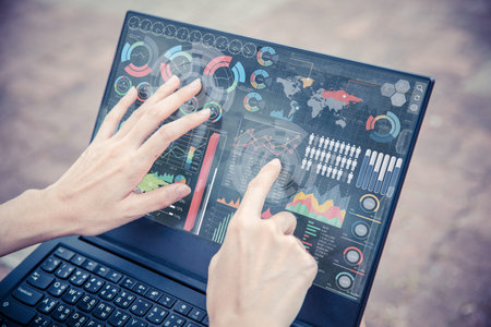 Businesswoman hand using advance technology computer touch screen business information data chart outdoor for decision support systemの写真素材
