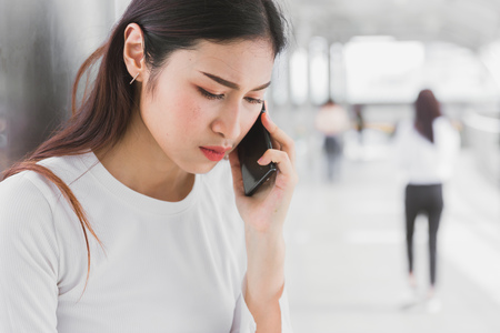 business office women calling smartphone with serious moody when lunch break.の写真素材