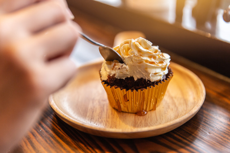 Eating cream cup cake sugar sweet delicious fat unhealthy food.の写真素材