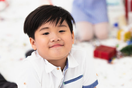Asian boy smile happy handsome model closeup action in the studio holiday party.の写真素材
