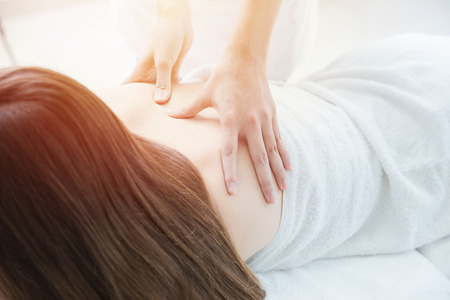 closeup back massage in spa white clean toneの写真素材