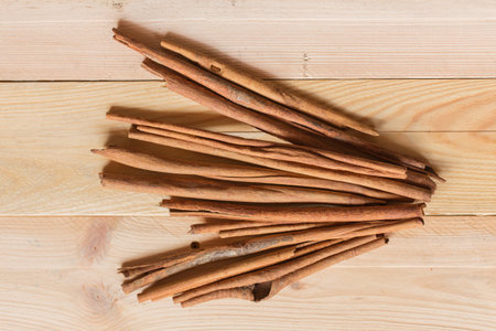 Top view of Cinnamon sticks on wood background, Asian nature aroma herb from bark.