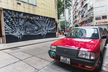 Central district Hong Kong city modern art street view with traditional style red taxi car most popular travel place in asia. 24 November 2017, Hongkong.のeditorial素材