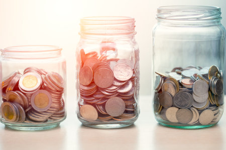 Personal financial or Saving Money concept, Coins collected in glass jar