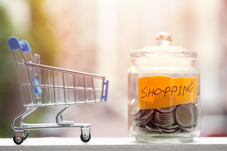 Saving money for Shopping budget, Coins keeping in jar with shopping cart