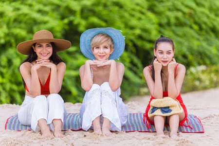 Three Asian fashion girls teen friend holiday vacation on the beachの写真素材