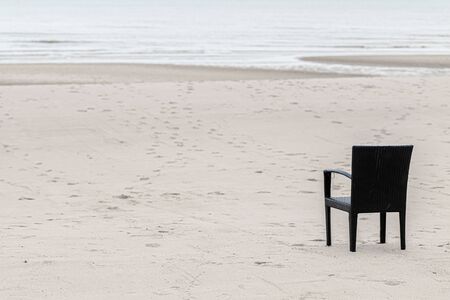 empty chair at the beach. nobody calm quiet lonely conceptの写真素材