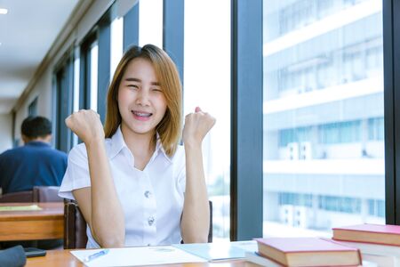 University Teen glad happy smile after good news pass examsの写真素材