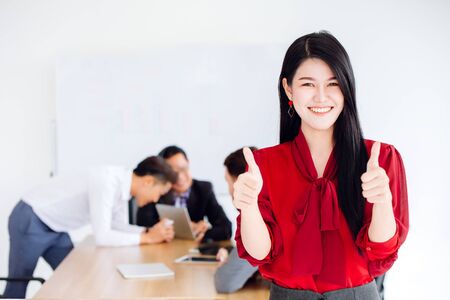 Asian business girl ceo show two hand thumb up good working together in office conceptの写真素材
