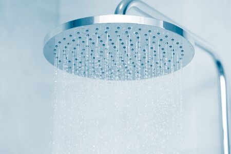 Rain water falling type shower head with blue clean toneの写真素材