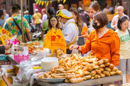 Vegetarian Festival (J Festival) In Thailand at Yaowarat or Bangkok China town street decoration with yellow flag for No animal meat food sign. 10 October 2018. Bangkok, THAILAND.のeditorial素材
