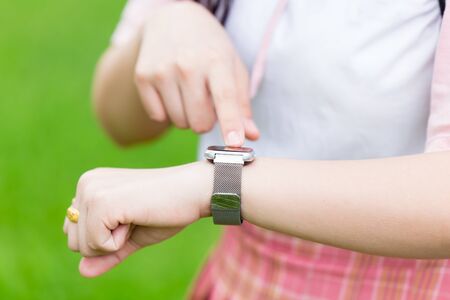 Smart watch closeup girl teen wist hand using watch touch screenの写真素材