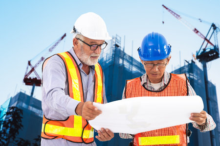 professional senior Engineer at construction site working together mix race with Asian elder